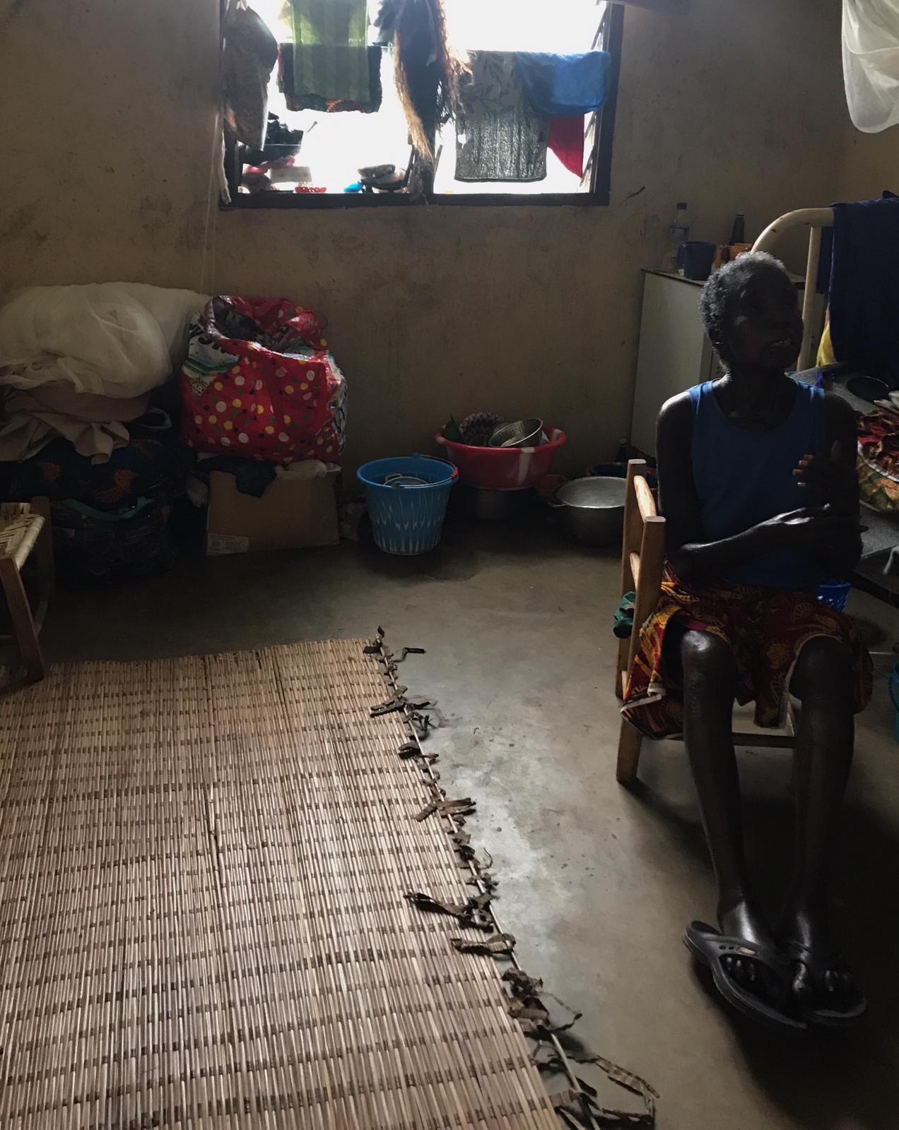 A woman affected by leprosy sits in her room within the rehabilitation centre after explaining her experiences with stigma and disability in the community. People affected by leprosy need to take long courses of multidrug therapy, for which they stay as in-patients for over one year.