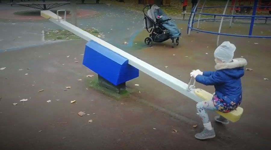 Child playing on seesaw