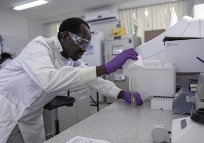 Caption: A researcher prepares a buffer solution for a high-throughput machine in a laboratory at the MRC/UVRI &amp; LSHTM Uganda Research Unit, Entebbe, Uganda.