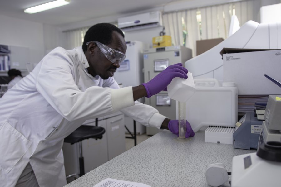 Caption: A researcher prepares a buffer solution for a high-throughput machine in a laboratory at the MRC/UVRI &amp; LSHTM Uganda Research Unit, Entebbe, Uganda.