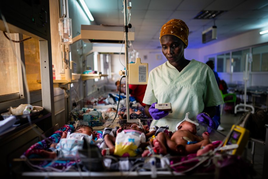 A research nurse screens a preterm baby for eligibility to the eKMC clinical trial, at Edward Francis Small Teaching Hospital, Banjul