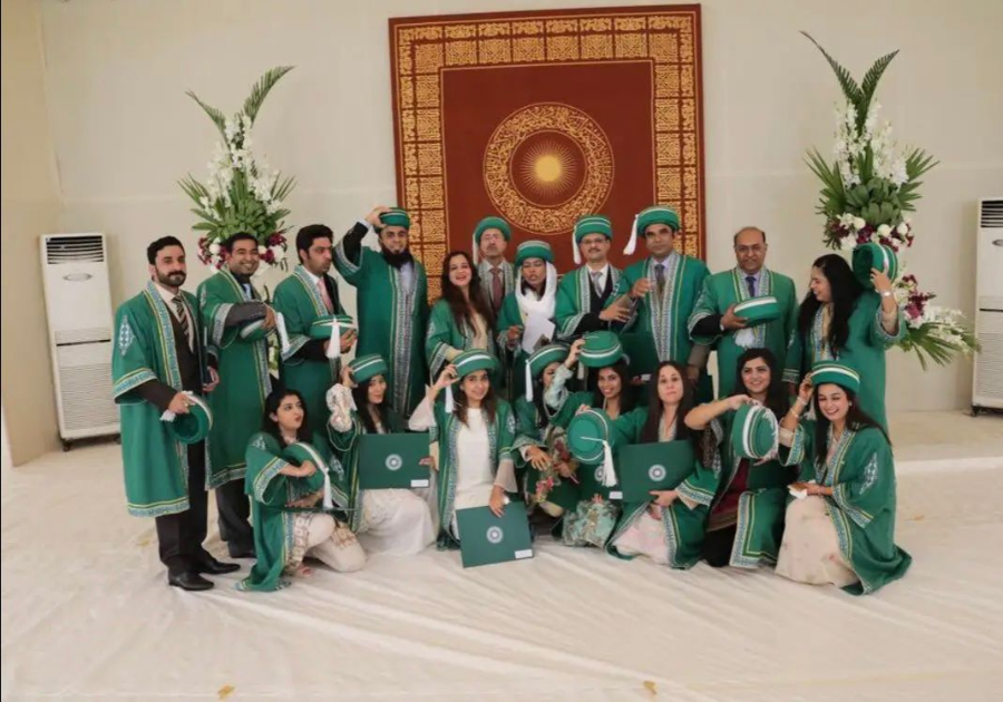 A graoup of graduates in green graduation gowns