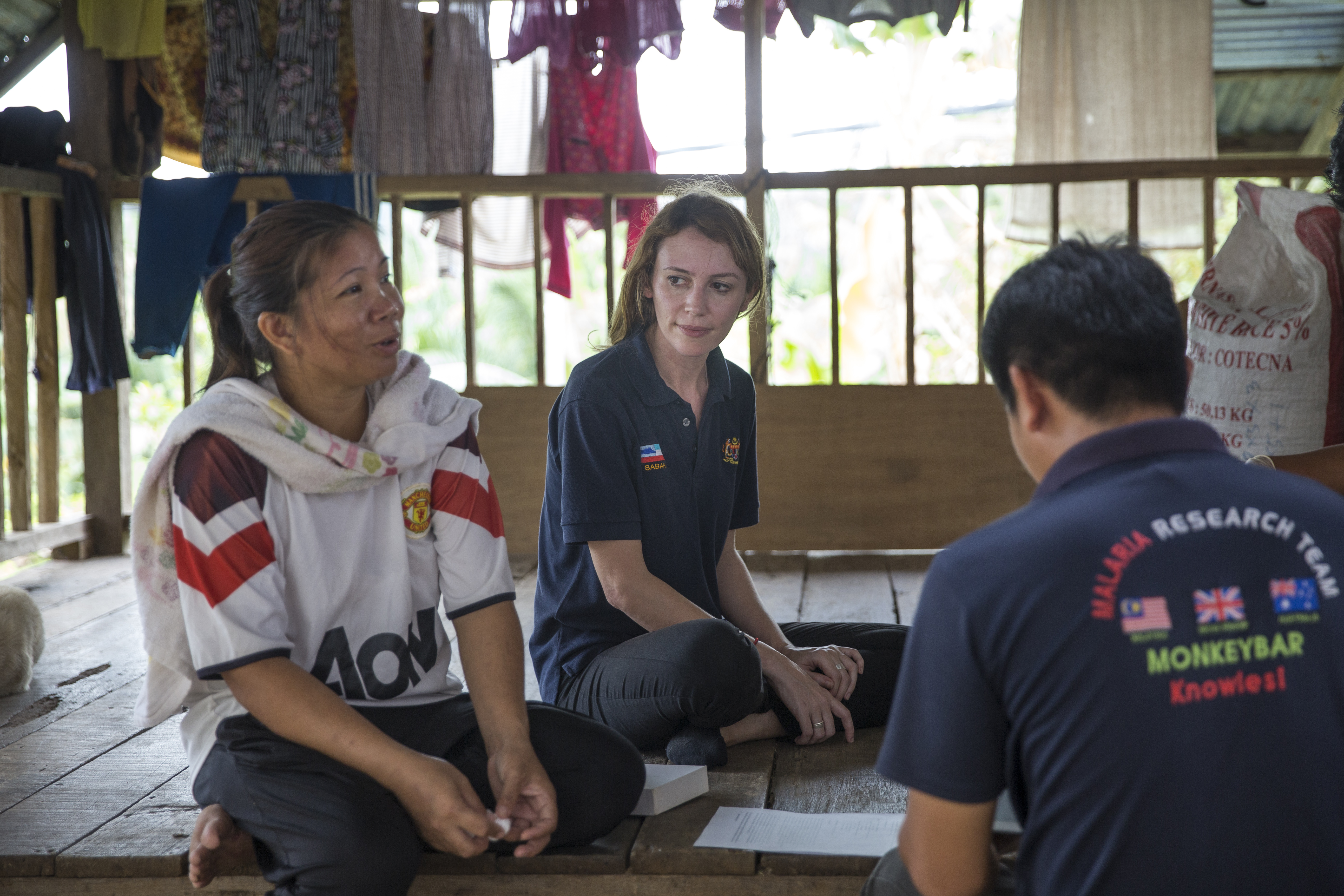 Kimberly Fornace, center, a LSHTM research fellow listens to local woman, left, living in a longhouse during blood sampling and interview in Kota Marudu, Sabah, Malaysia, Friday, March 17, 2017. (Joshua Paul for LSHTM)