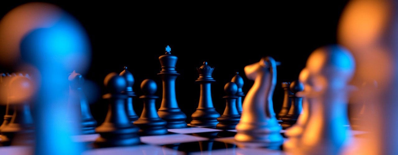 Close up of chessmen on chessboard with the focus on a queen. Credit: Shutterstock