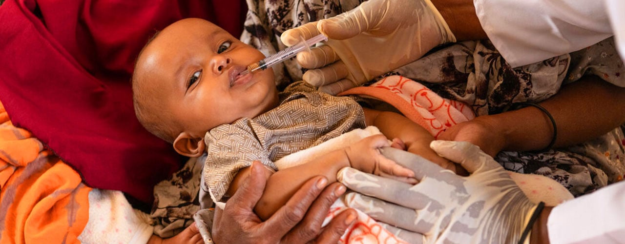 Health worker Worku, 26, vaccinates twins Hassan and Hussein, 6-months at a Save the Children-supported health centre in Somali Region, Ethiopia. Credit: Save the Children
