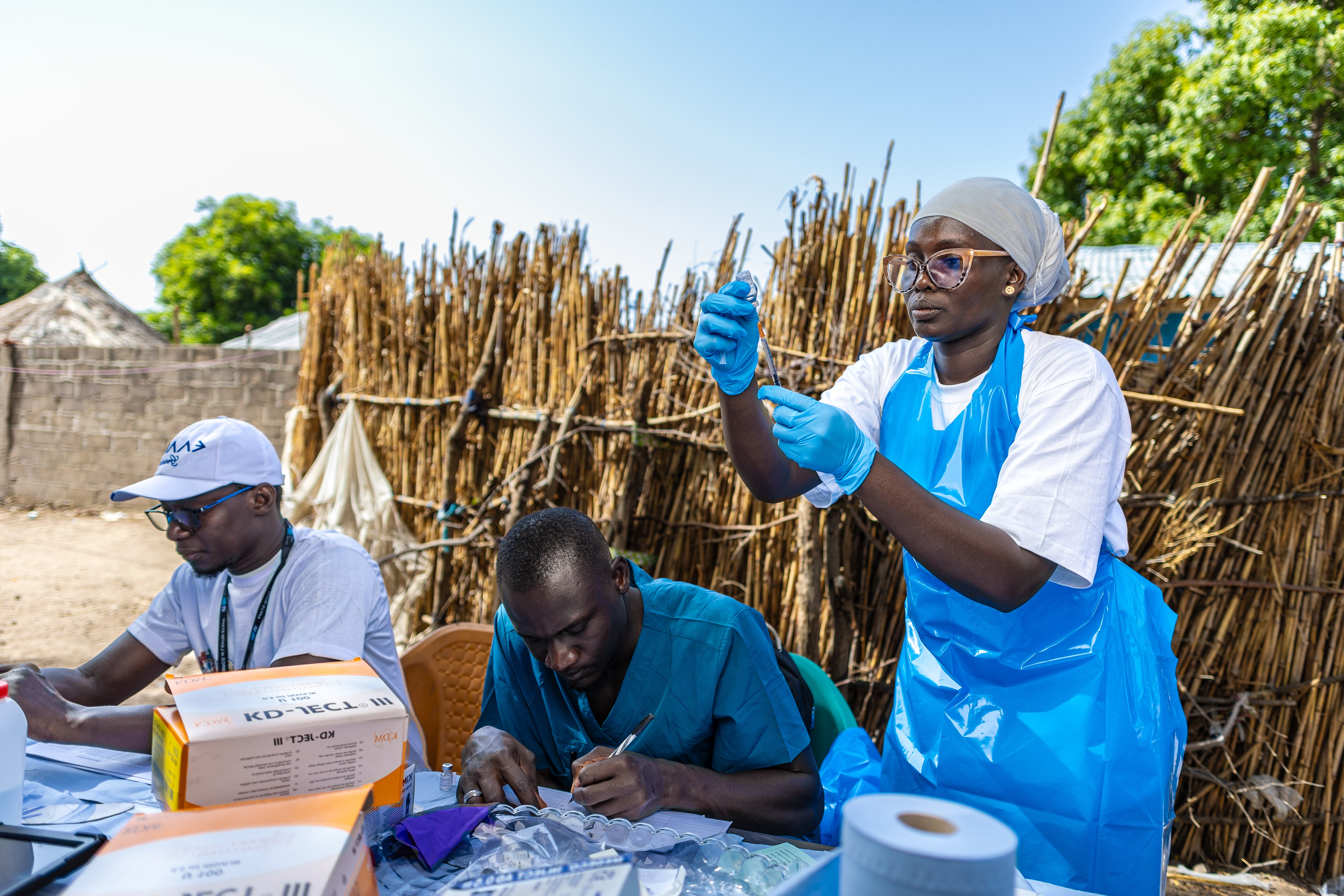 A field staff preparing a vaccine in a rural community