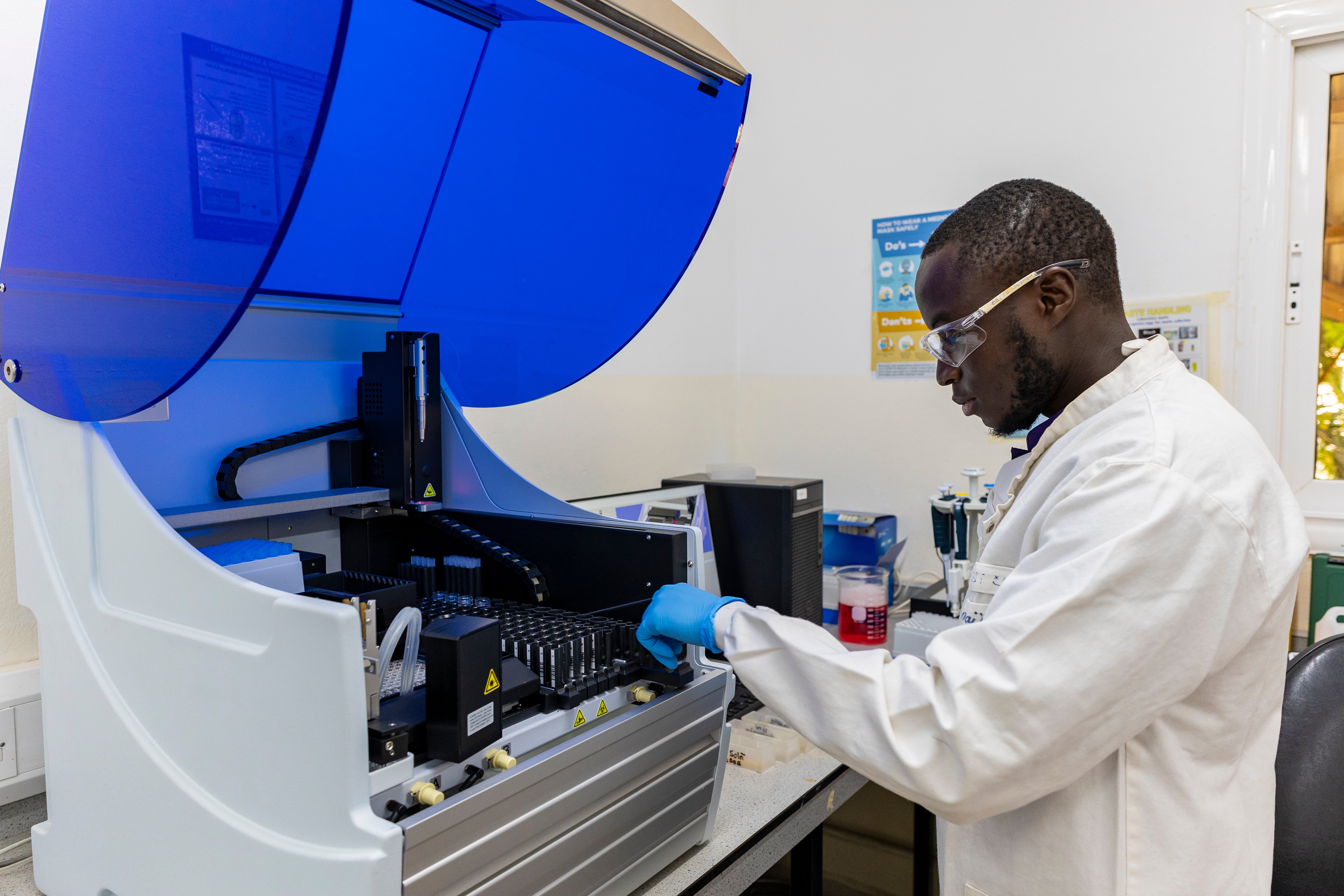 Serology Lab scientist operating a machine