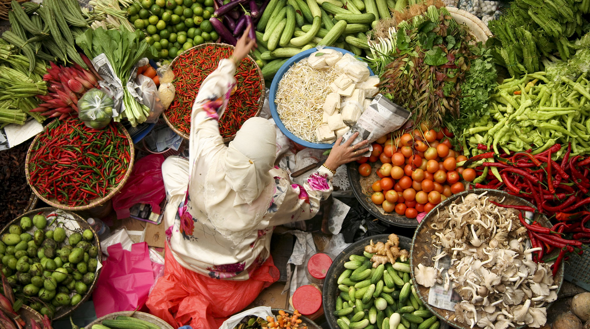 Woman selling fresh vegetables at a market in Kota Baru, Malaysia