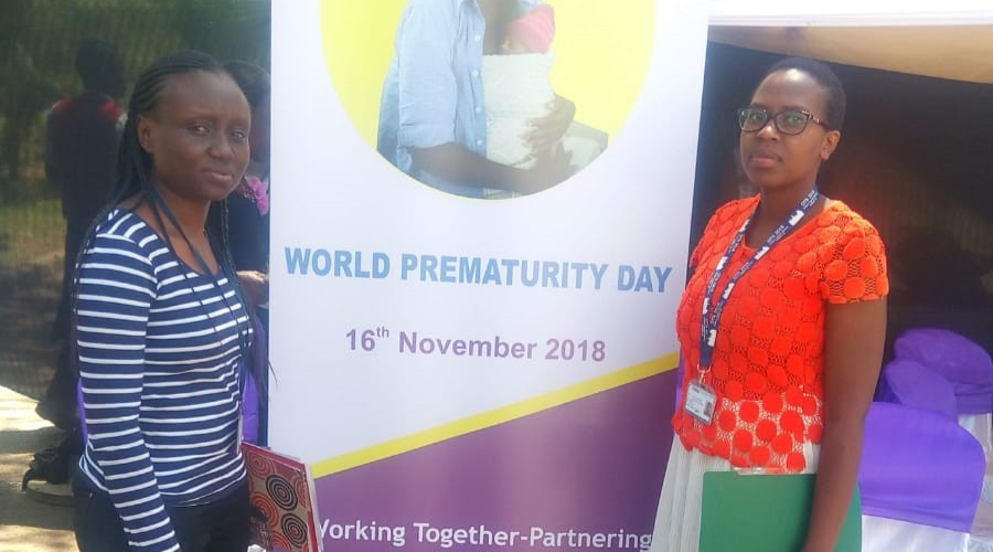 Joyline and a colleague stood either side of a world prematurity day banner