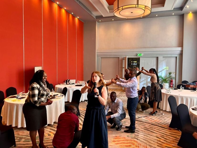People roleplaying a response scenario in a hotel conference room.