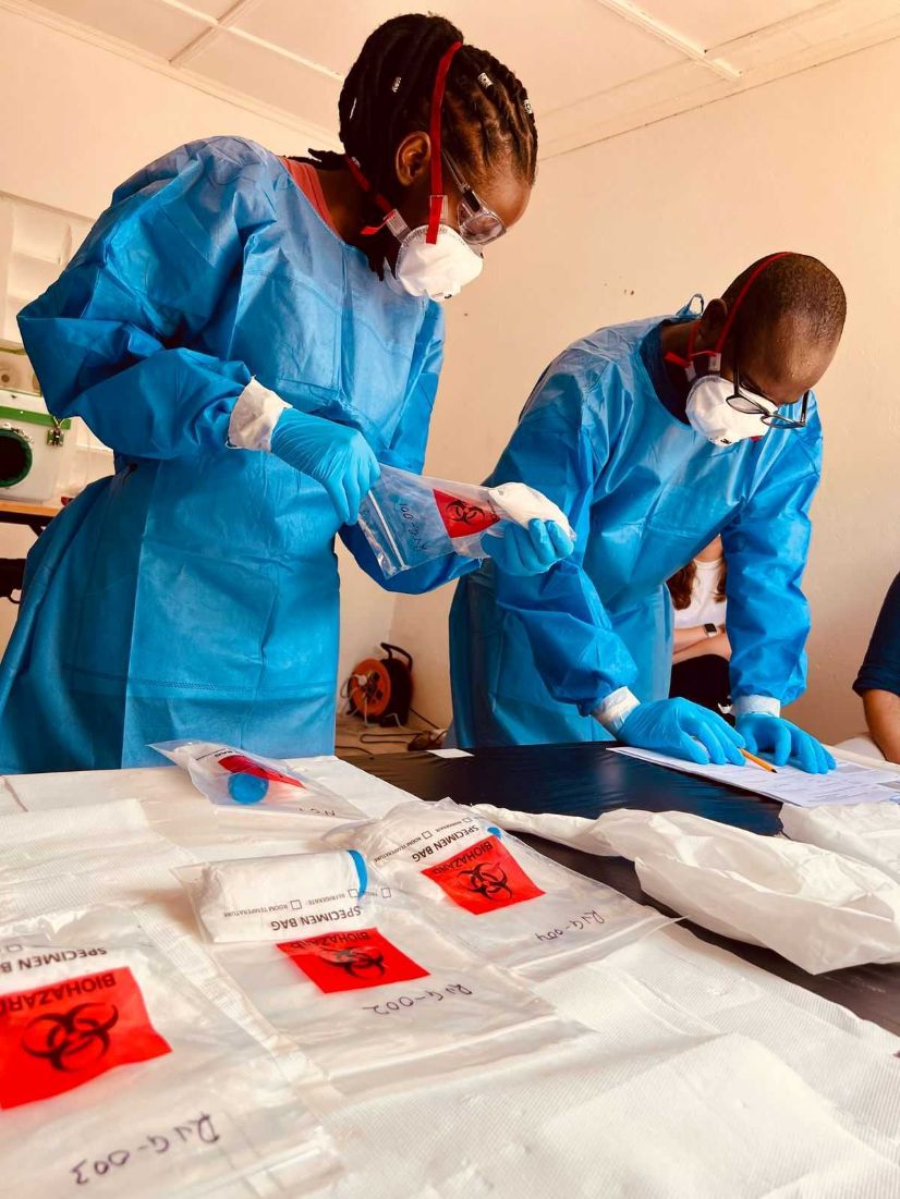 KEMRI Wellcome trust staff wearing PPE and colelcting samples during training.