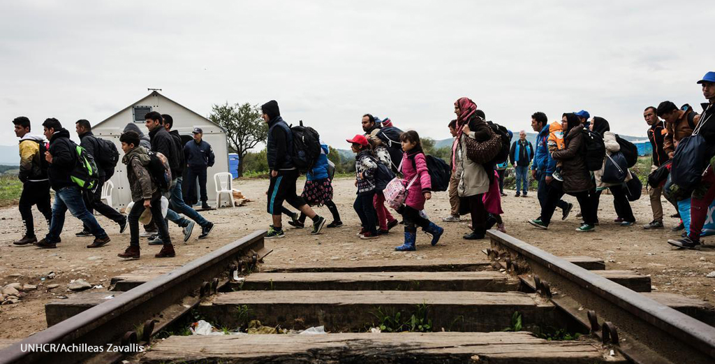 Migrants crossing train track