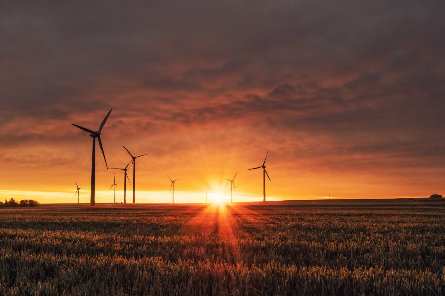 Sunset on landscape with wind turbines. Credit: Graham Ooko/Alamy