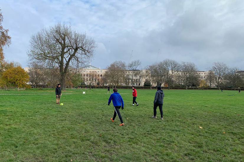People playing football in Regent's Park, photo by Annalise Morelock.