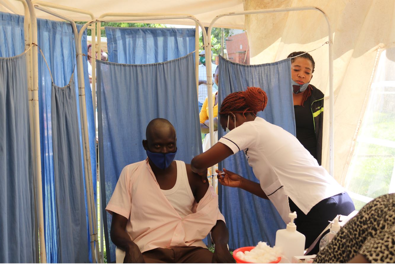 A Community member receives a COVID-19 vaccine dose at the UVRI Clinic 