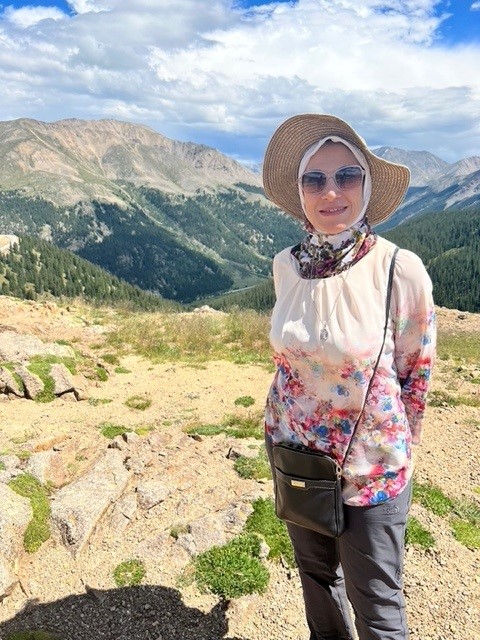 Shereen Hussein standing in front of hilly landscape
