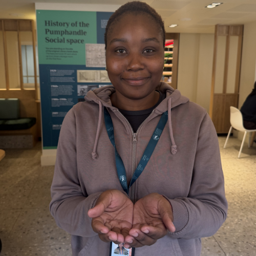 A student with Give to Gain hand gesture