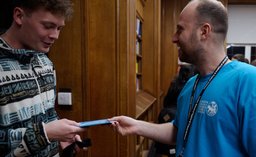 Vil given a booklet by a student ambassador at LSHTM Open Evening.