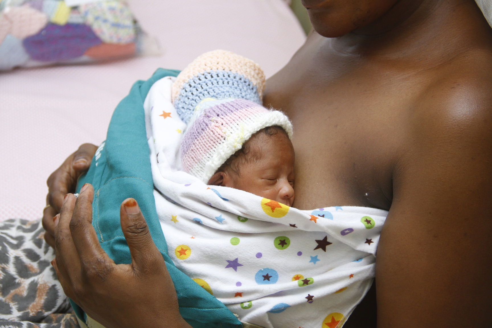 A mother of twins provides kangaroo mother care as part of the OMWaNA trial in Uganda.