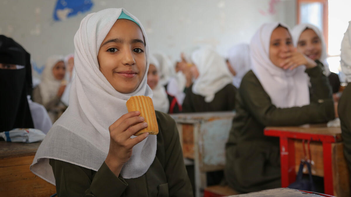 Aziza, seventh grade, eats a date bar in a classroom at Salah Al-Din School in Sana'a city. Credit: WFP/Ahmed Haleem