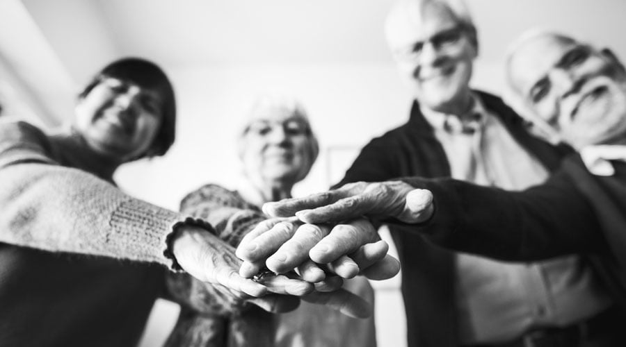 Old people joining hands