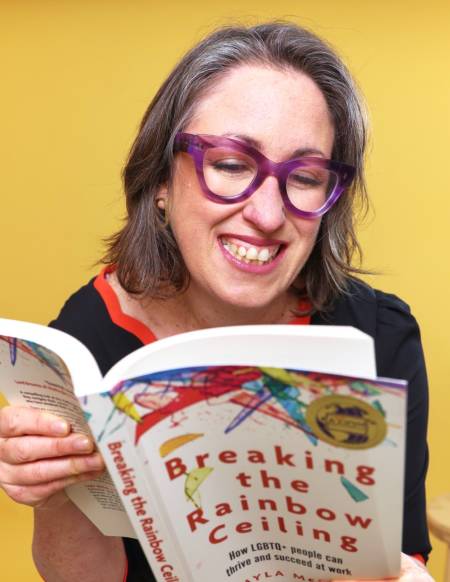 Layla McCay with book Breaking the Rainbow Ceiling