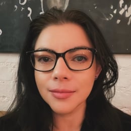 Woman with dark brown hair and glasses