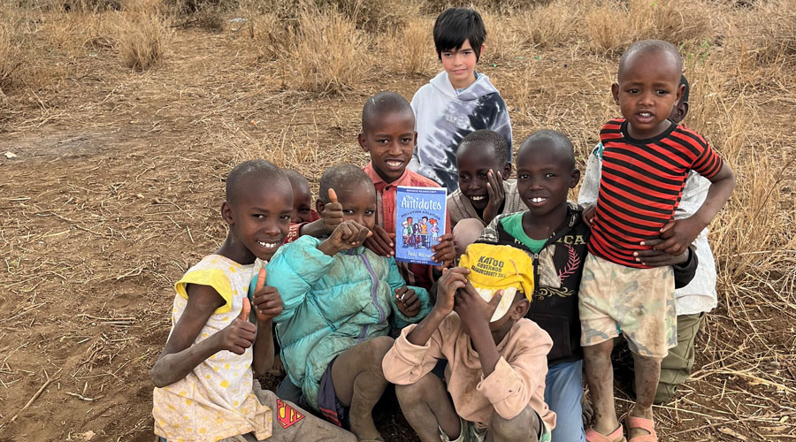 Kenyan children with book: The Antidote (Patty Mechael)