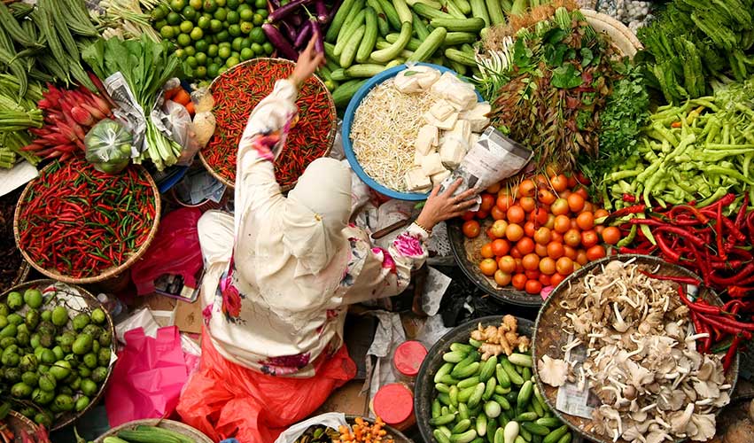 Woman selling fresh vegetables at a market in Kota Baru, Malaysia