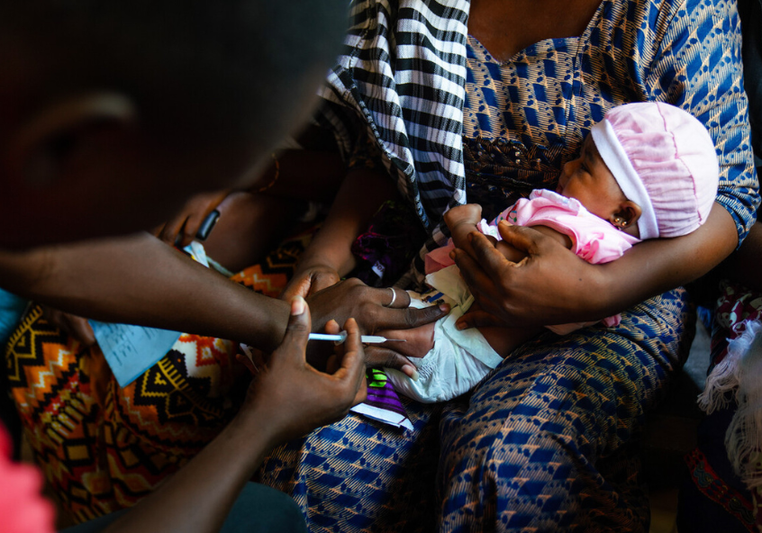 A clinician administers a dose of pneumococcal vaccine, Basse Hospital, The Gambia.