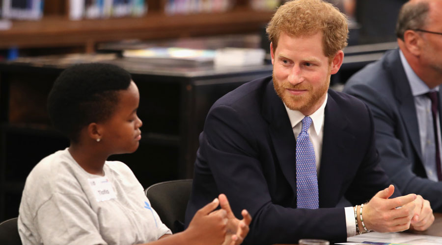 Prince Harry talking to a student whilst visiting the London School of Hygiene & Tropical Medicine