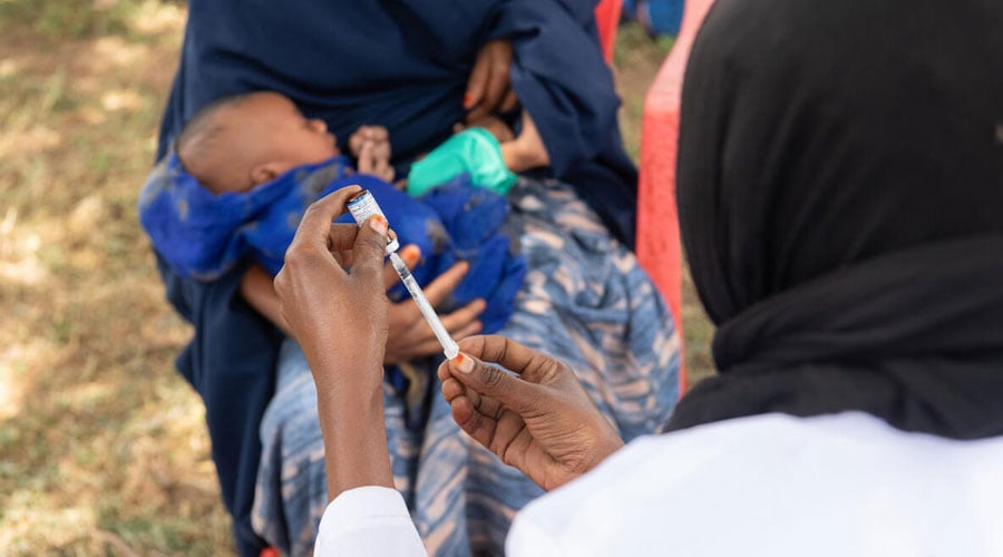 Health worker Miraha, 25, vaccinates Amar, 2 months, at a mobile outreach session in a remote community in Oromia Region, Ethiopia.