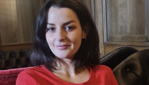 Rachel wearing a red top.