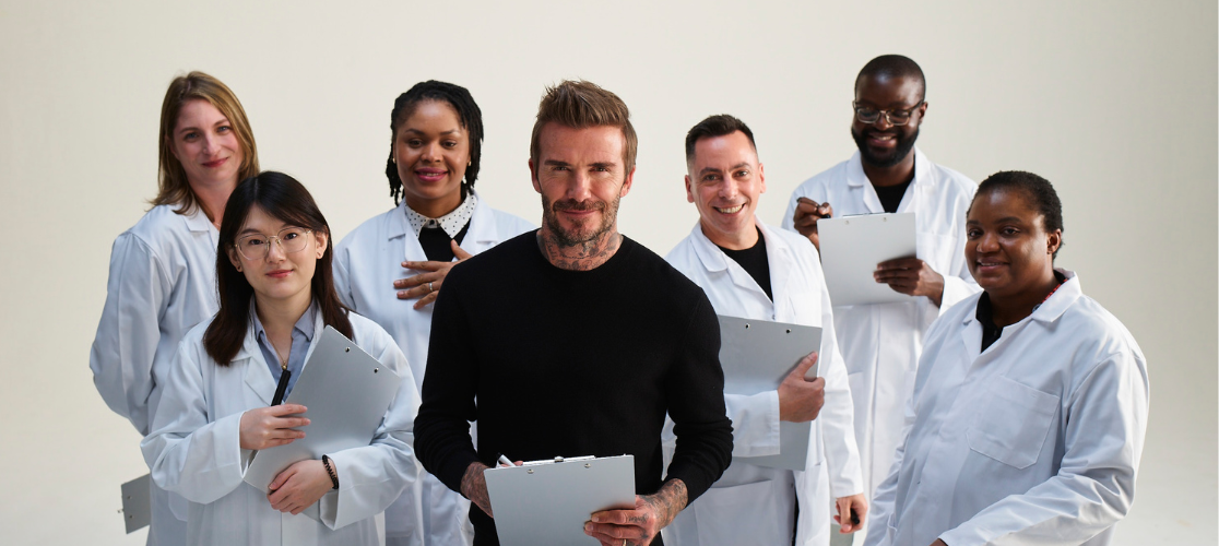 Scientists standing with David Beckham for the Zero Malaria campaign, 2021