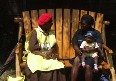 Caption: In Harare, a lay health worker provides problem solving therapy to a young mother. Credit: Friendship Bench