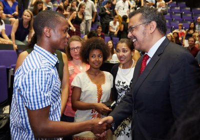 Dr Tedros Adhanom Ghebreyesus greeting a student