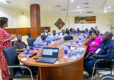 A group of individuals having a meeting in a seminar room