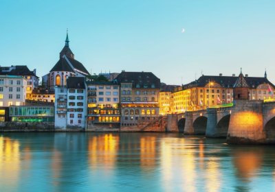 Photo of river, bridge and city buildings in Basel city centre.