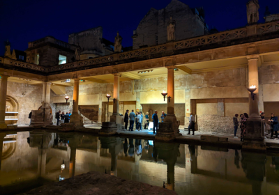  A photo of conference delegates networking at the historical Roman Bath site at night