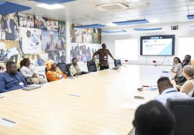 Individuals having a meeting in a seminar room