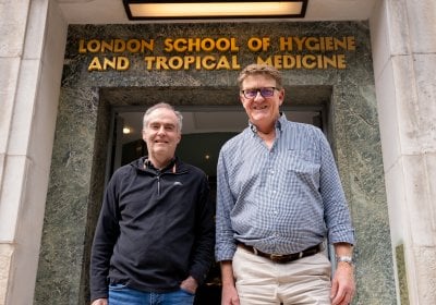 Professor David Baker (left) and Professor Colin Sutherland (right) standing at the LSHTM entrance in Keppel Street