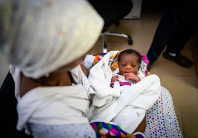 A small baby with his mother