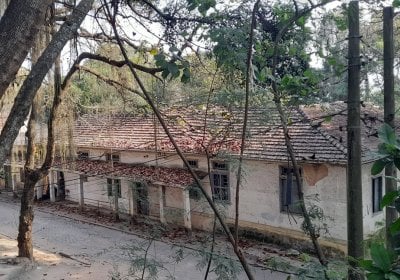 Hospital Curupaiti, a former leprosy colony located Jacarepaguá́, Rio de Janeiro. Photograph shows the dilapidated building set back amongst trees and shrubs