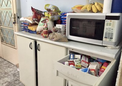 By Veronkia Reichenberger. In Brasilia, in a participant's house, we can see food on the counter and the medicine drawer open