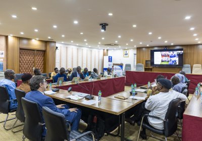 Individuals in a closed room having a meeting