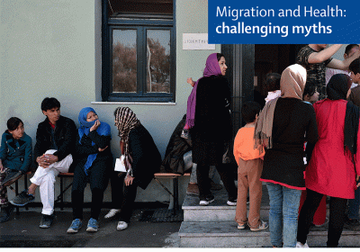 Caption: Migrants outside building. Credit: Lancet