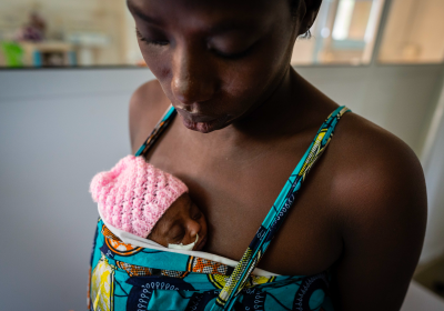 A mother holds her baby on her chest