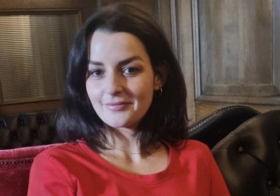Rachel wearing a red top.
