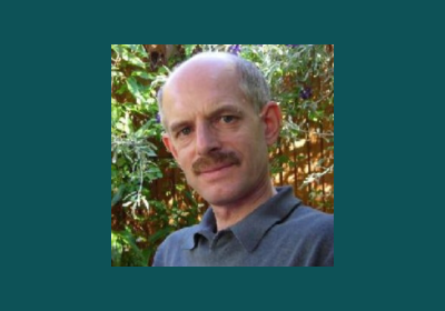 Picture of Richard Hayes on a dark green background