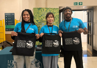 LSHTM Students holding LSHTM tote bags